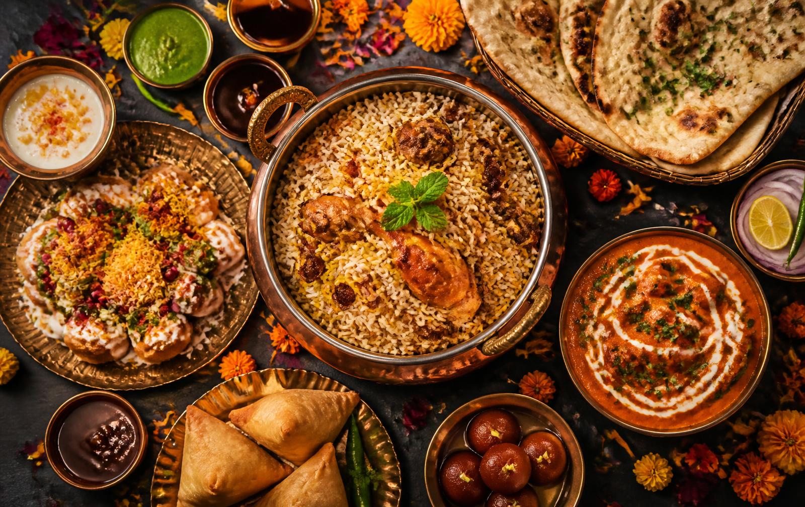 Indian feast of biryani, butter chicken, naan and chaat